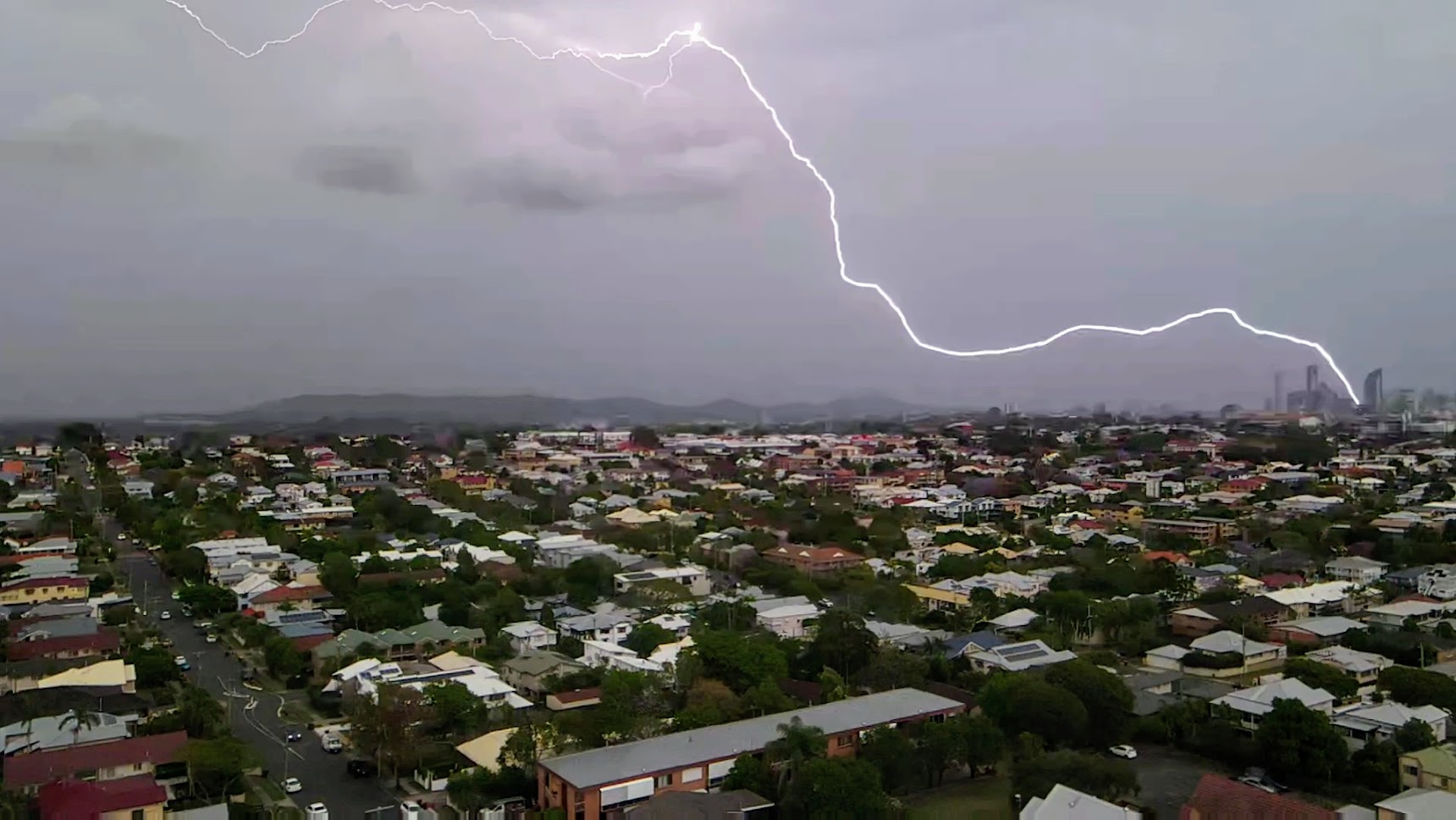 Lightning strike over QLD suburban rooftops